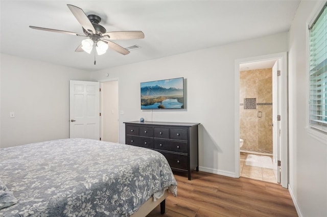 921 Torchwood Dr, Deland, FL 32724 - bedroom featuring wood finished floors, ensuite bathroom, baseboards, and ceiling fan