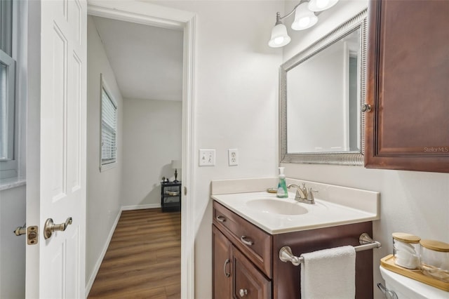 921 Torchwood Dr, Deland, FL 32724 - half bathroom with wood finished floors, vanity, toilet, and baseboards