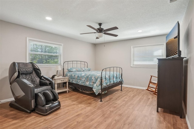 921 Torchwood Dr, Deland, FL 32724 - bedroom with light wood-style flooring, baseboards, recessed lighting, a textured ceiling, and ceiling fan