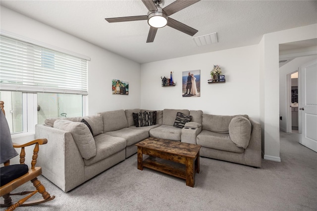 carpeted living room with ceiling fan