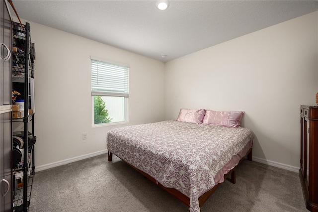 bedroom with carpet floors and baseboards