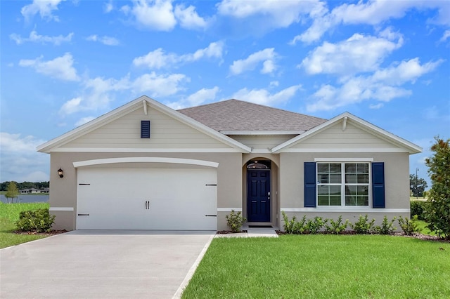 2105 Greenwood Oak Dr, Ocoee, FL 34761 - view of front of house with a front lawn, driveway, an attached garage, stucco siding, and a shingled roof