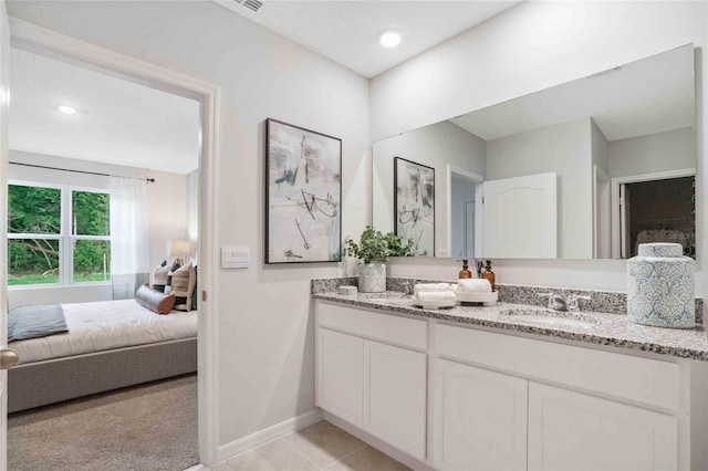 2105 Greenwood Oak Dr, Ocoee, FL 34761 - ensuite bathroom with double vanity, baseboards, tile patterned flooring, and recessed lighting