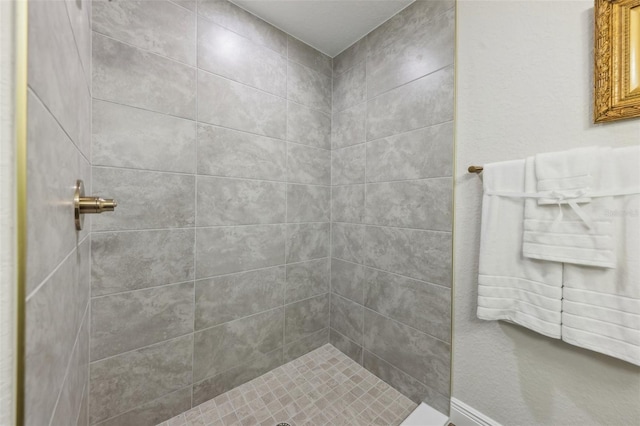 full bath with a tile shower