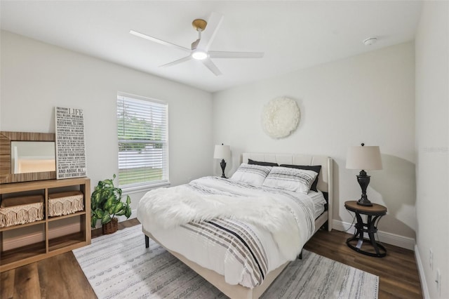 bedroom with wood finished floors, baseboards, and a ceiling fan