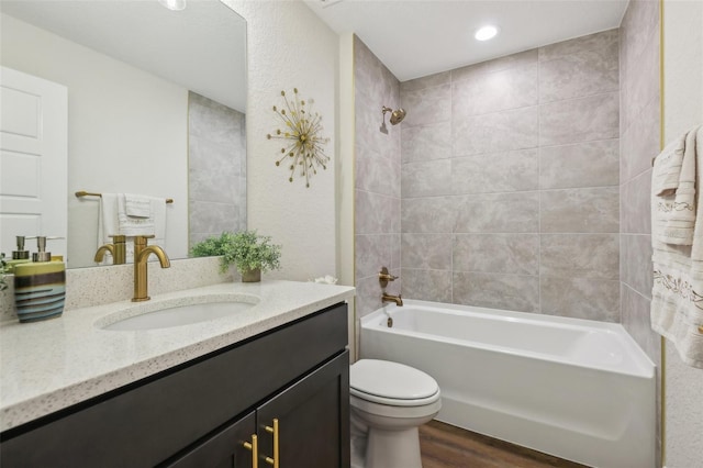 full bath featuring toilet, wood finished floors, tub / shower combination, and vanity