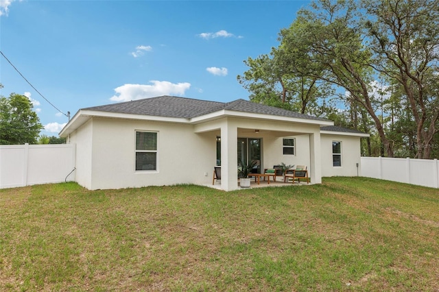 rear view of house with a ceiling fan, stucco siding, and a patio