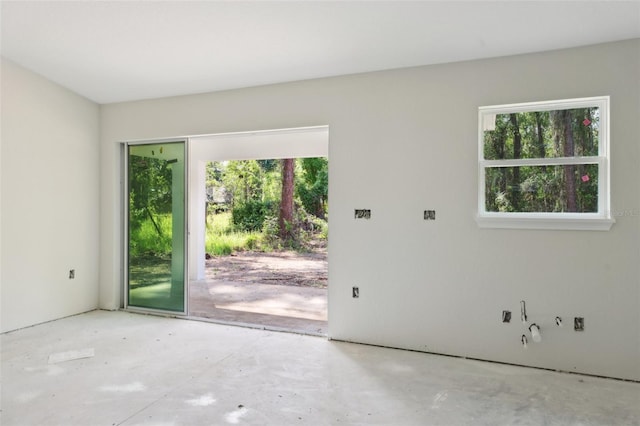 unfurnished room featuring plenty of natural light