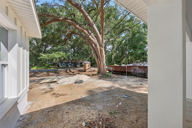 view of yard featuring view of scattered trees and fence