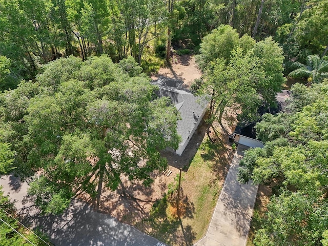 view from above of property with a heavily wooded area