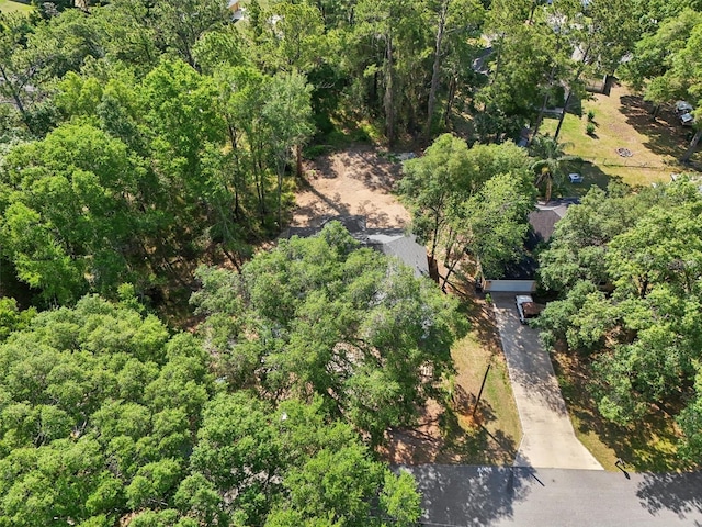 aerial view of property's location featuring a heavily wooded area