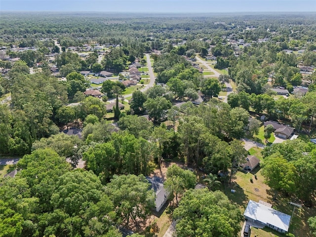aerial view of property's location featuring a forest
