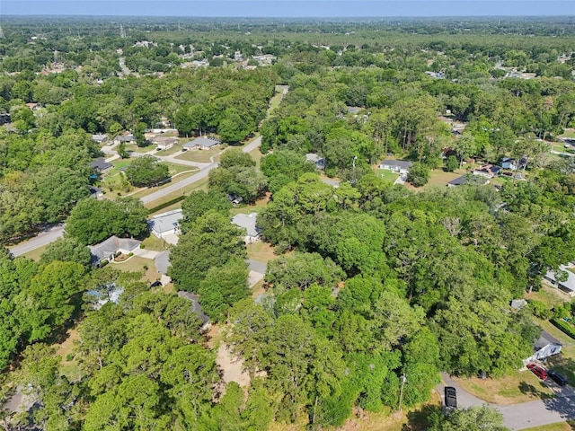 aerial view of property and surrounding area featuring a forest