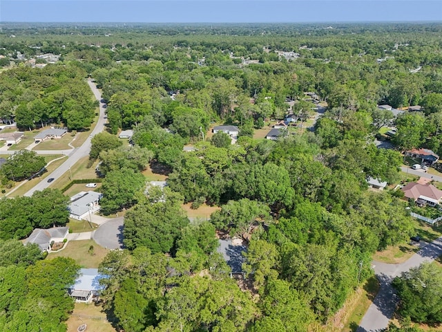 aerial view of property and surrounding area with a forest