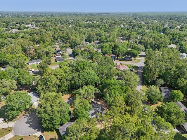 view of property location with a heavily wooded area
