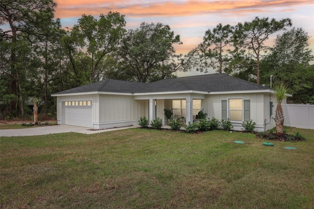 ranch-style home with a garage, driveway, and a shingled roof