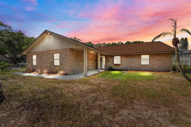 10545 Parkway Dr, Clermont, FL 34711 - view of side of property featuring brick siding and a lawn