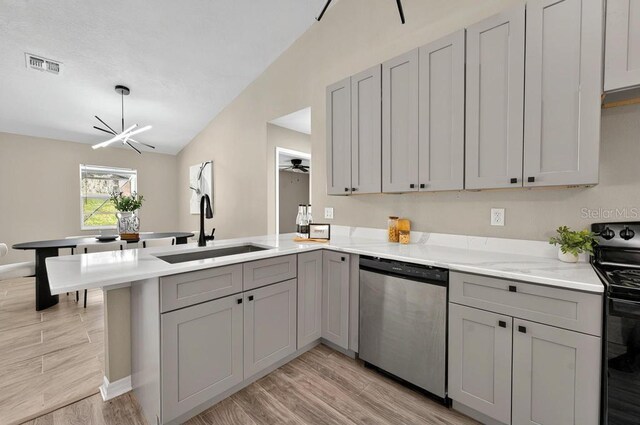 10545 Parkway Dr, Clermont, FL 34711 - kitchen with dishwasher, electric range, a sink, a peninsula, and gray cabinets