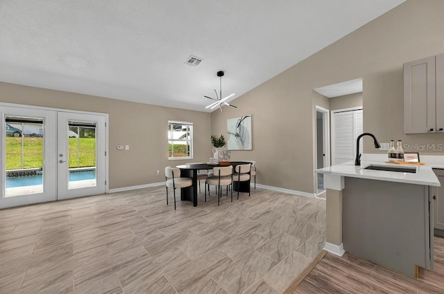 10545 Parkway Dr, Clermont, FL 34711 - dining room with vaulted ceiling, french doors, and baseboards