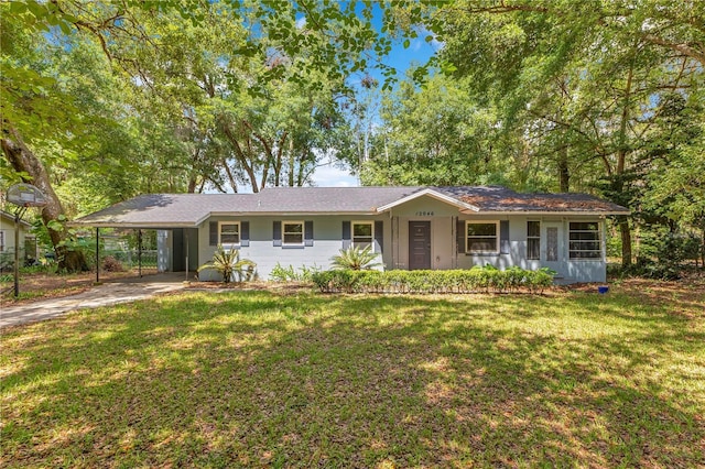 12046 SE 135th Ave, Ocklawaha, FL 32179 - ranch-style house featuring a front lawn, a carport, and driveway