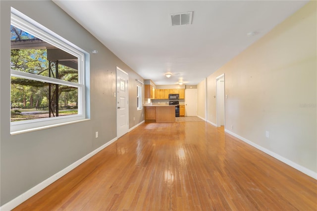 12046 SE 135th Ave, Ocklawaha, FL 32179 - unfurnished living room with light wood-style floors and baseboards