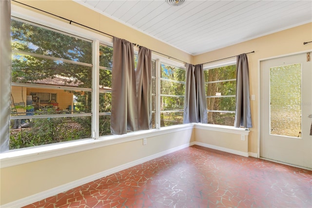 12046 SE 135th Ave, Ocklawaha, FL 32179 - unfurnished sunroom with baseboards and wood ceiling