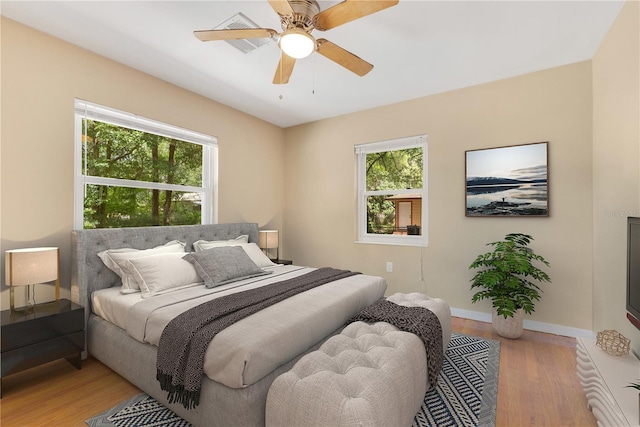 12046 SE 135th Ave, Ocklawaha, FL 32179 - bedroom featuring light wood finished floors, baseboards, and a ceiling fan