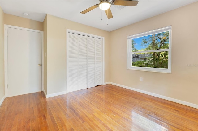 12046 SE 135th Ave, Ocklawaha, FL 32179 - unfurnished bedroom featuring a closet, baseboards, and light wood-style flooring