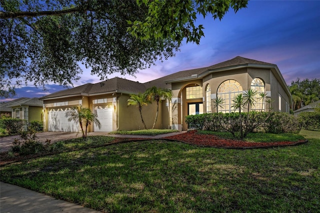 10030 Chatham Oaks Ct, Orlando, FL 32836 - mediterranean / spanish-style home with stucco siding, a garage, driveway, and a front yard