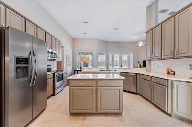 10030 Chatham Oaks Ct, Orlando, FL 32836 - kitchen featuring stainless steel appliances, decorative backsplash, light countertops, a peninsula, and a ceiling fan
