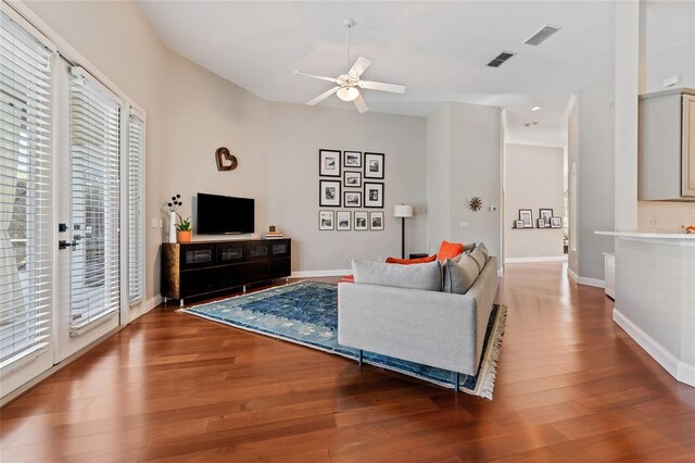 10030 Chatham Oaks Ct, Orlando, FL 32836 - living area with healthy amount of natural light, a ceiling fan, wood finished floors, and baseboards