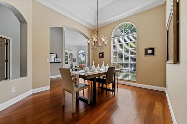 10030 Chatham Oaks Ct, Orlando, FL 32836 - dining space with plenty of natural light, dark wood-style floors, arched walkways, and ornamental molding