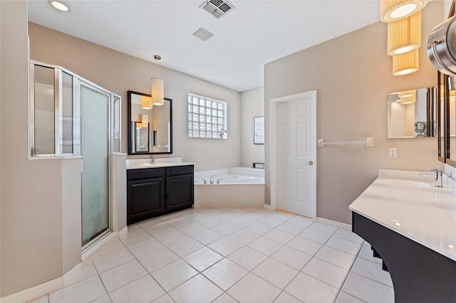 10030 Chatham Oaks Ct, Orlando, FL 32836 - bathroom with a garden tub, a stall shower, two vanities, tile patterned flooring, and baseboards