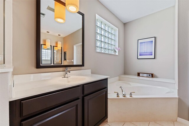 10030 Chatham Oaks Ct, Orlando, FL 32836 - bathroom featuring vanity, a garden tub, and tile patterned floors