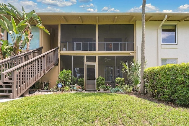 200 Maitland Ave Unit 122, Altamonte Springs, FL 32701 - back of house with a sunroom, stucco siding, a yard, and stairs