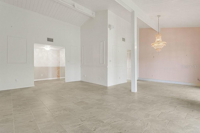 200 Maitland Ave Unit 122, Altamonte Springs, FL 32701 - unfurnished living room with high vaulted ceiling, a chandelier, beamed ceiling, and baseboards