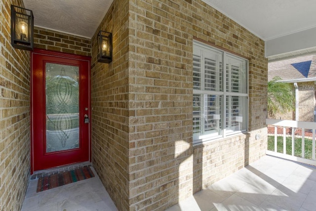 25 Reflections Village Dr, Ormond Beach, FL 32174 - view of exterior entry featuring covered porch and brick siding