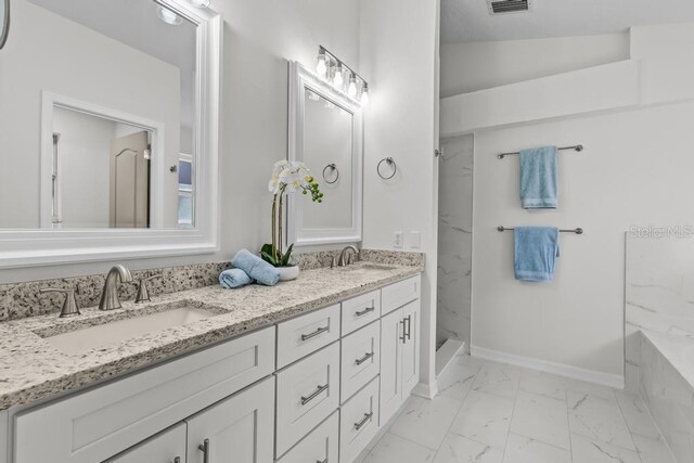 25 Reflections Village Dr, Ormond Beach, FL 32174 - bathroom featuring marble look tiles, double vanity, a marble finish shower, and baseboards
