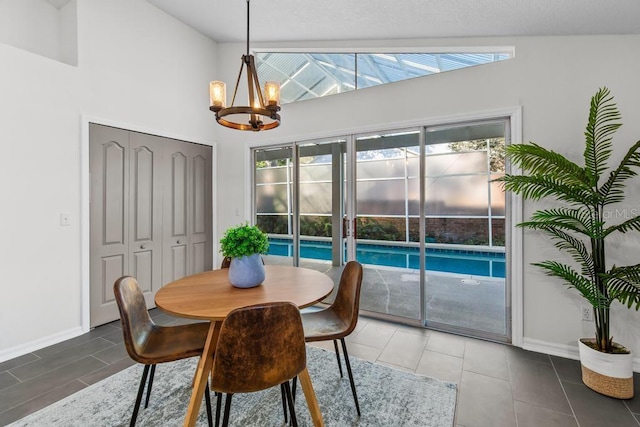 25 Reflections Village Dr, Ormond Beach, FL 32174 - dining area featuring a chandelier, baseboards, high vaulted ceiling, and tile patterned flooring