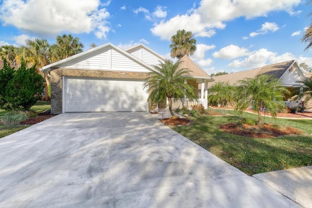 25 Reflections Village Dr, Ormond Beach, FL 32174 - ranch-style home with a garage, concrete driveway, a front lawn, brick siding, and covered porch