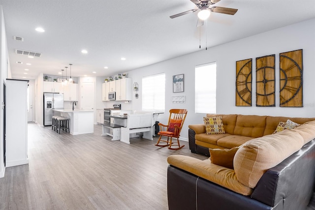 200 Summershore Dr, Auburndale, FL 33823 - living area featuring ceiling fan, recessed lighting, light wood-style floors, and baseboards