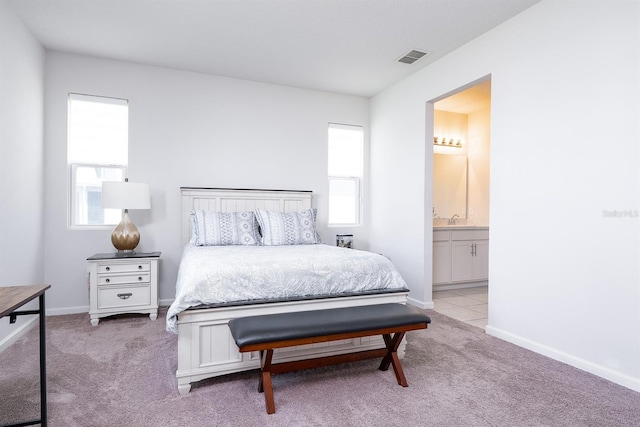 200 Summershore Dr, Auburndale, FL 33823 - carpeted bedroom with ensuite bathroom, baseboards, and a sink