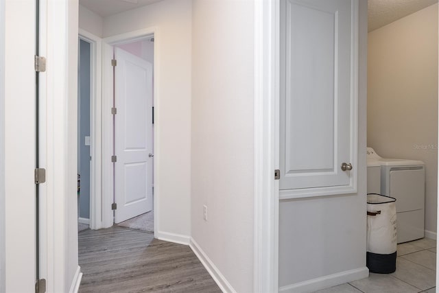 200 Summershore Dr, Auburndale, FL 33823 - hallway featuring washer and clothes dryer, baseboards, and light wood-type flooring