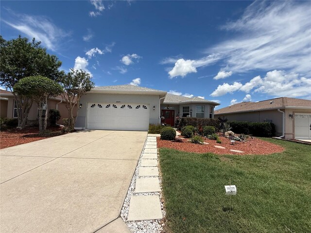 10075 SW 91st Pl, Ocala, FL 34481 - ranch-style house with stucco siding, concrete driveway, a garage, and a front yard