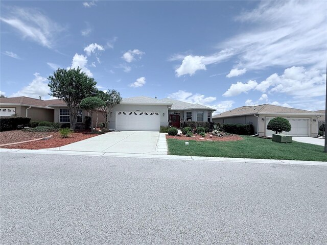 10075 SW 91st Pl, Ocala, FL 34481 - single story home featuring an attached garage, concrete driveway, a front yard, and stucco siding