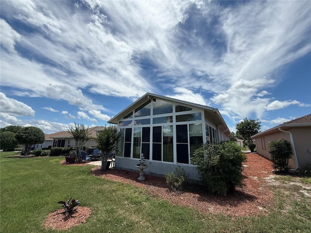 10075 SW 91st Pl, Ocala, FL 34481 - rear view of house with a sunroom and a lawn