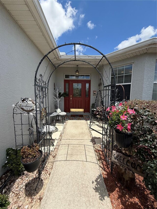 10075 SW 91st Pl, Ocala, FL 34481 - doorway to property featuring stucco siding