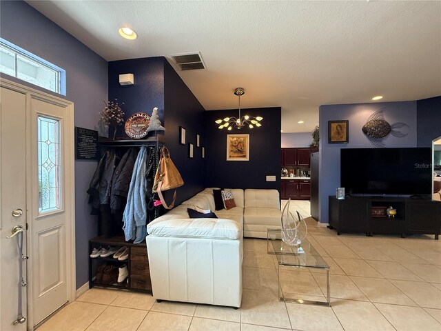 10075 SW 91st Pl, Ocala, FL 34481 - living room featuring a chandelier, light tile patterned floors, recessed lighting, a textured ceiling, and baseboards
