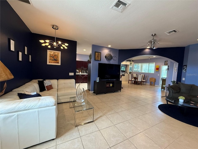 10075 SW 91st Pl, Ocala, FL 34481 - living area with arched walkways, a chandelier, a ceiling fan, light tile patterned floors, and a textured ceiling
