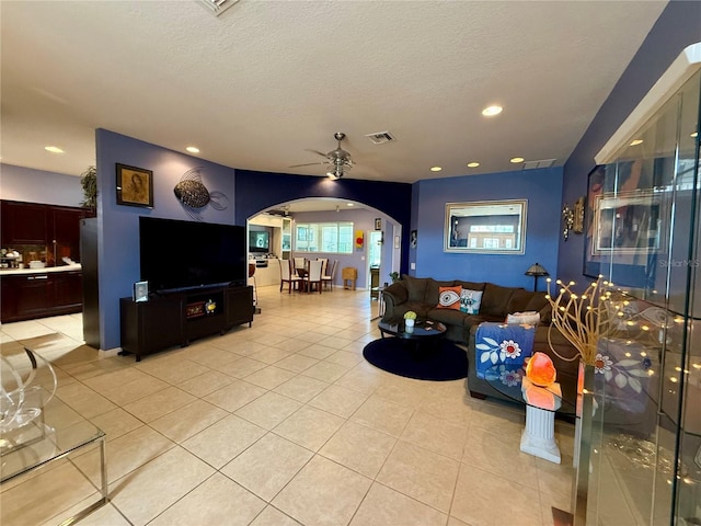 10075 SW 91st Pl, Ocala, FL 34481 - living room featuring arched walkways, ceiling fan, light tile patterned floors, recessed lighting, and a textured ceiling